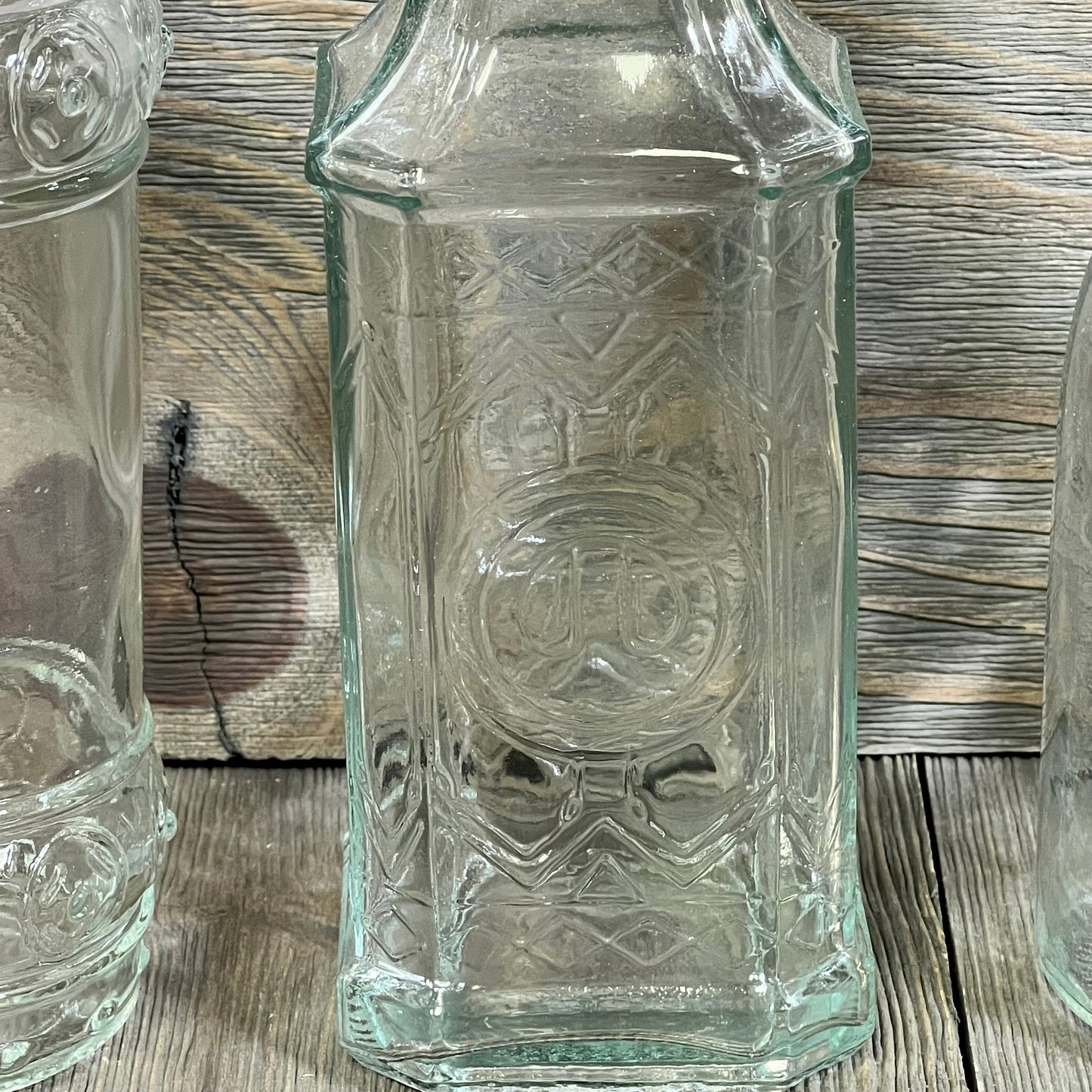 Clear glass bottle with intricate design, cork top, 16oz capacity, from BULK PARADISE 6 pack, ideal for decor.