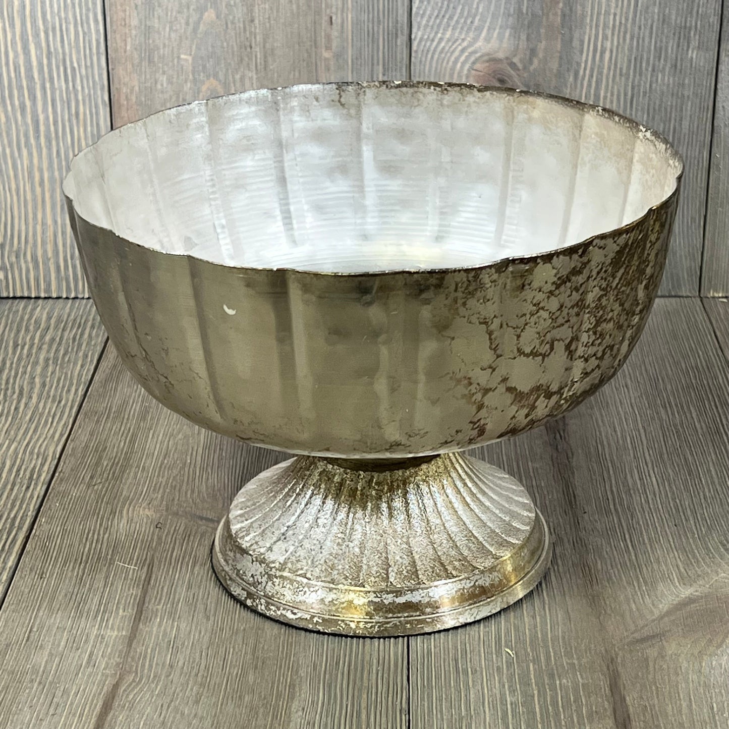 Distressed champagne metal compote bowl with a vintage look, perfect for elegant indoor or outdoor event decor.