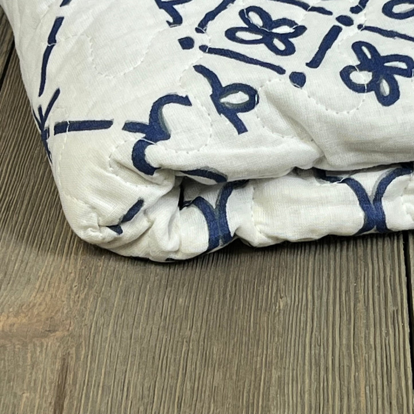 Lush Decor Monique Throw in blue with intricate patterns, folded on a wooden surface, size 50 x 60 inches.