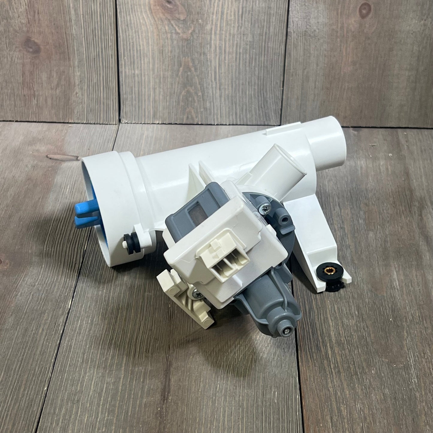 Efficient GE washer drain pump with filter, model WH11X29539, replacement part for washing machines, white casing.
