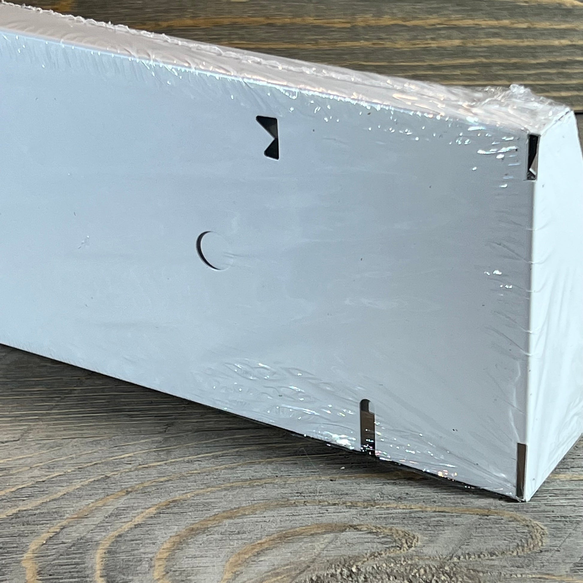 White Blulu vent cover in packaging, showcasing sleek modern design for home floor or wall installation.