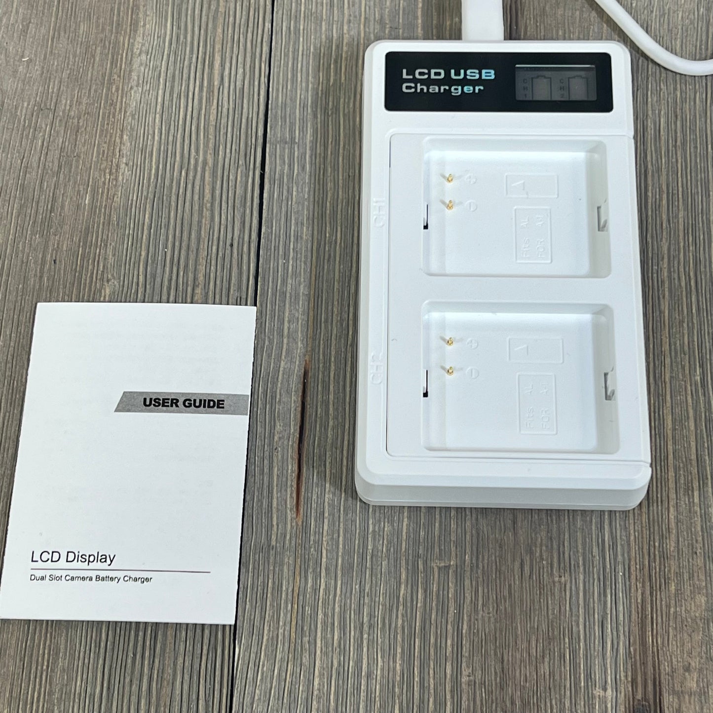 LCD dual charger station for Arlo Pro batteries with user guide, featuring USB-C connectivity for efficient charging.