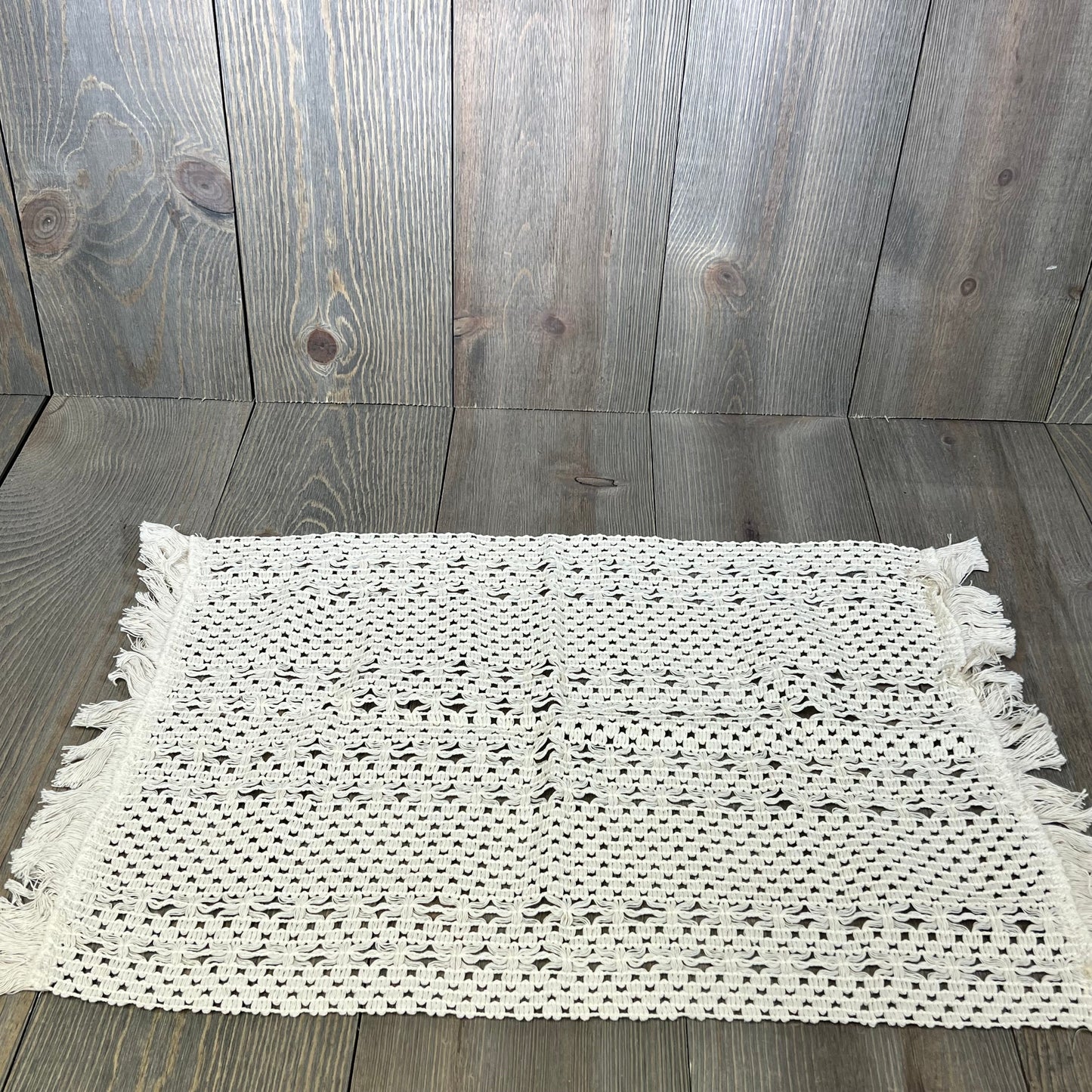 Cream beige macrame table mat with tassels, perfect for farmhouse dining decor. Durable cotton linen, 12x20 inches.