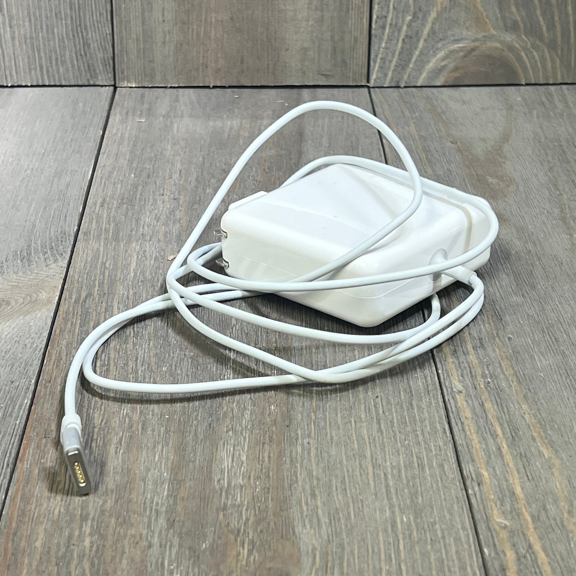 White 140W Type C charger for MacBook Pro and Air (2021-2025) with 6.6FT magnetic cable on wooden surface.