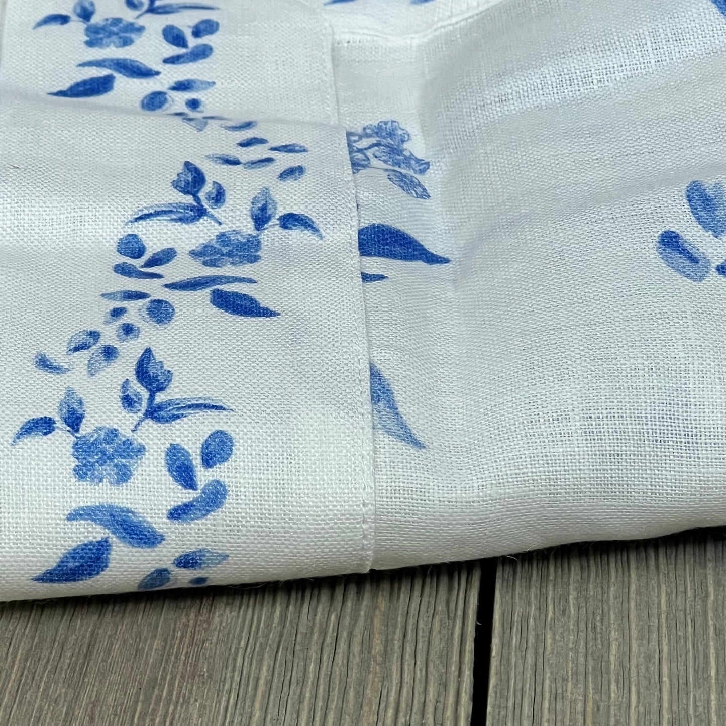 Blue floral linen table runner, 48-inch, with Jolie Fleur print. Perfect for summer decor. Handcrafted and machine washable.