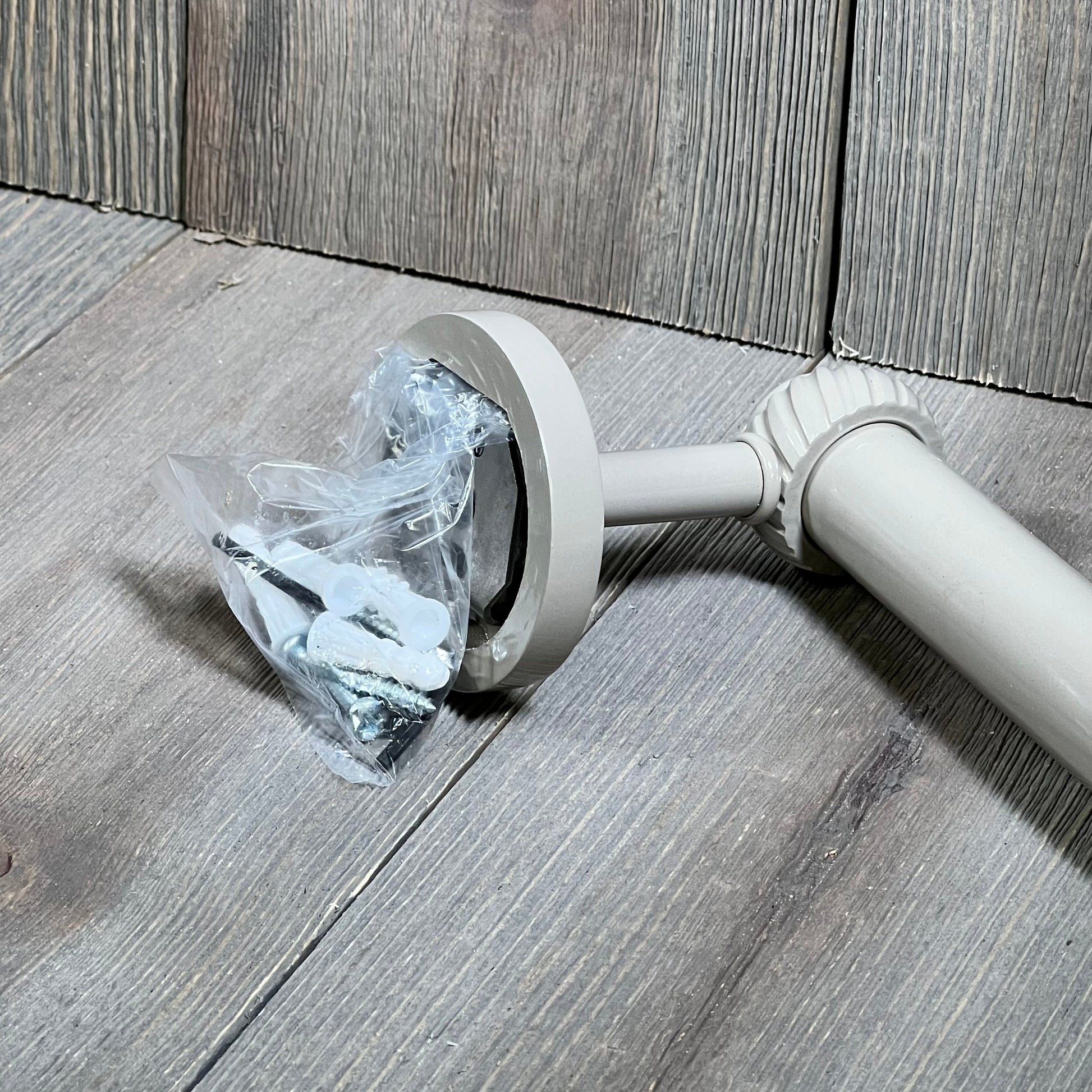 Shaded beige towel bar with twist detail from Allied Brass Satellite Orbit Two Collection, displayed on wood surface.