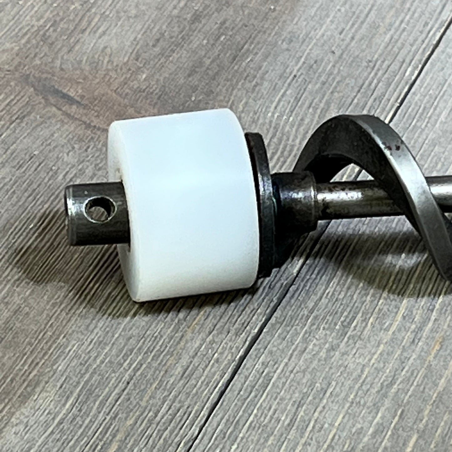Close-up of 17-inch auger shaft screw push rod with motor bushing kit, compatible with most Traeger pellet grills.
