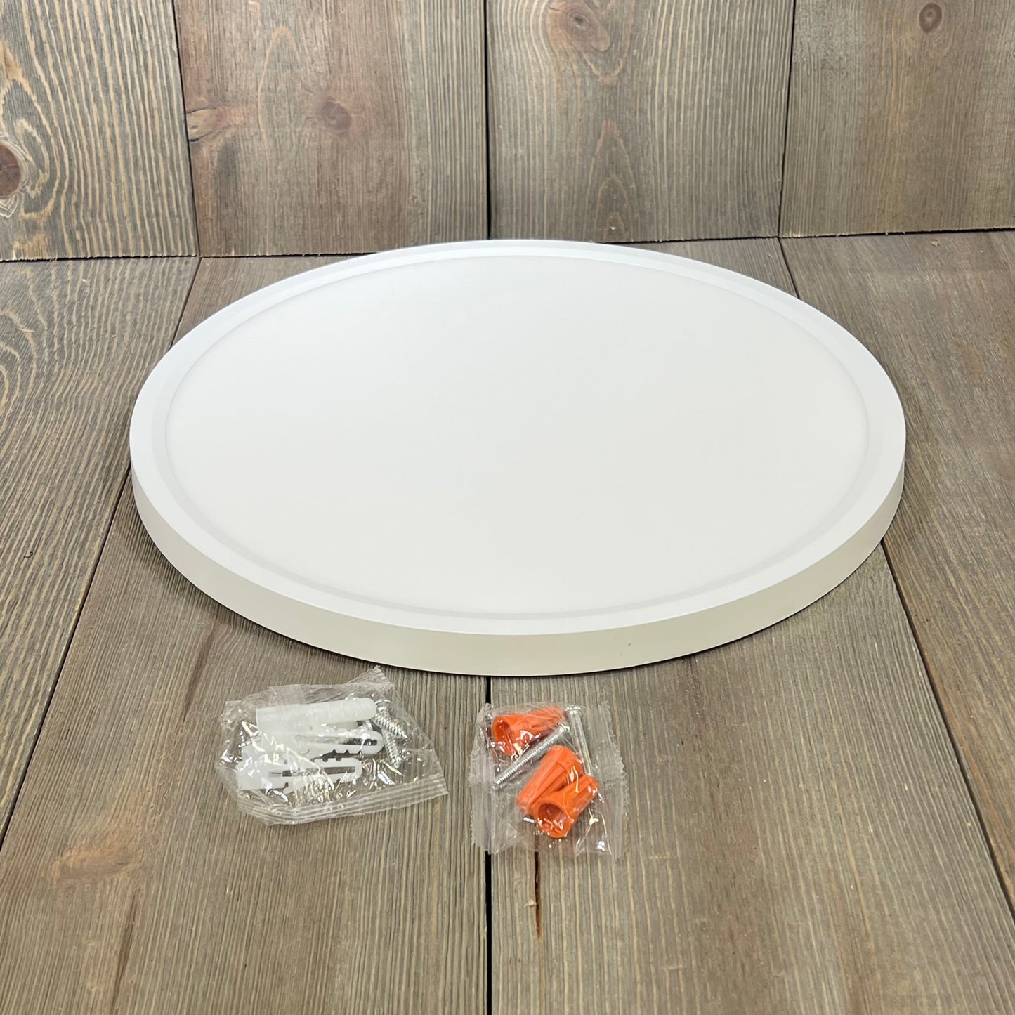 Super slim 12-inch Brightever LED ceiling light fixture with installation accessories on wooden surface.