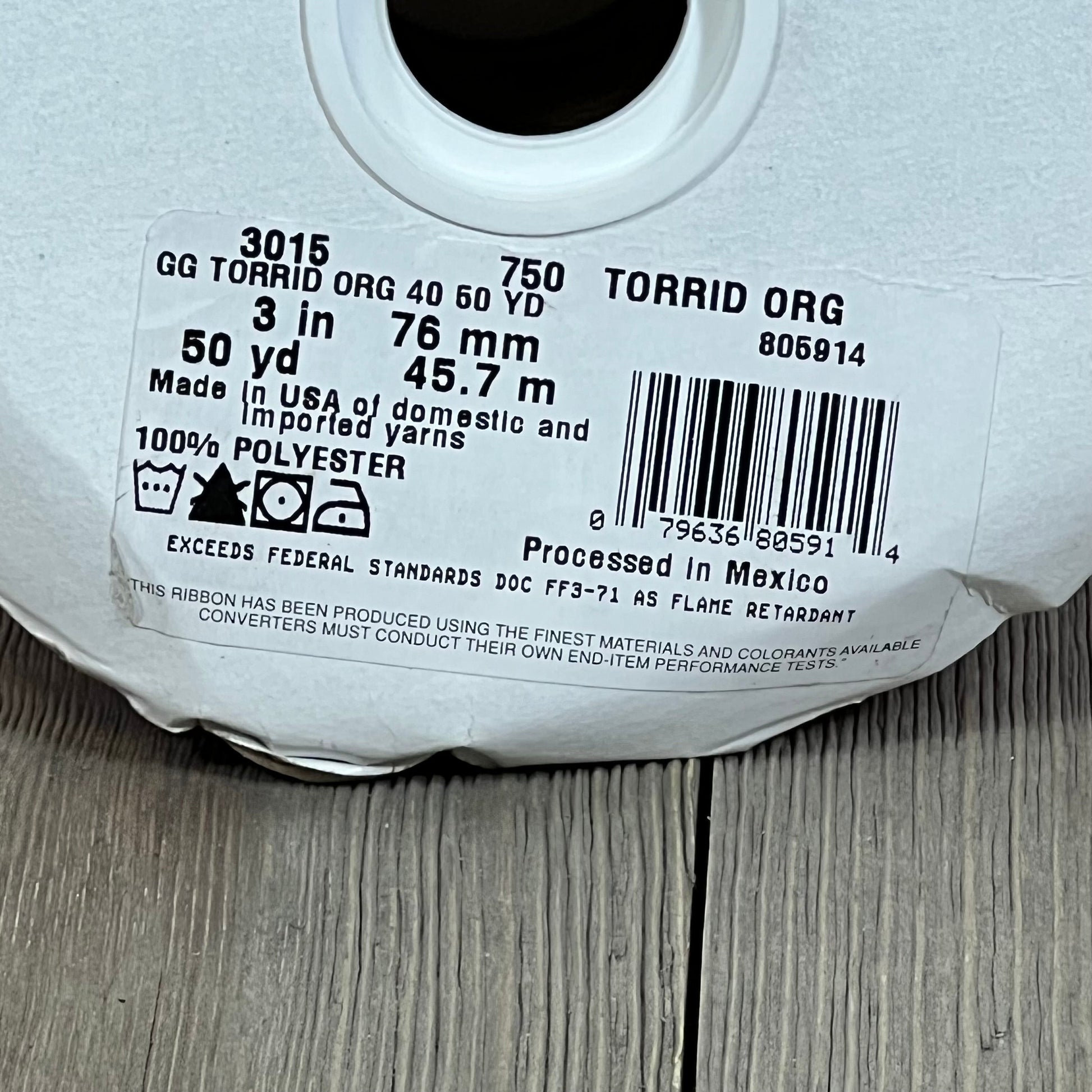 Grosgrain ribbon label in Torrid Orange, 3 inches wide, 50 yards, 100% polyester, showcasing specifications and origin.