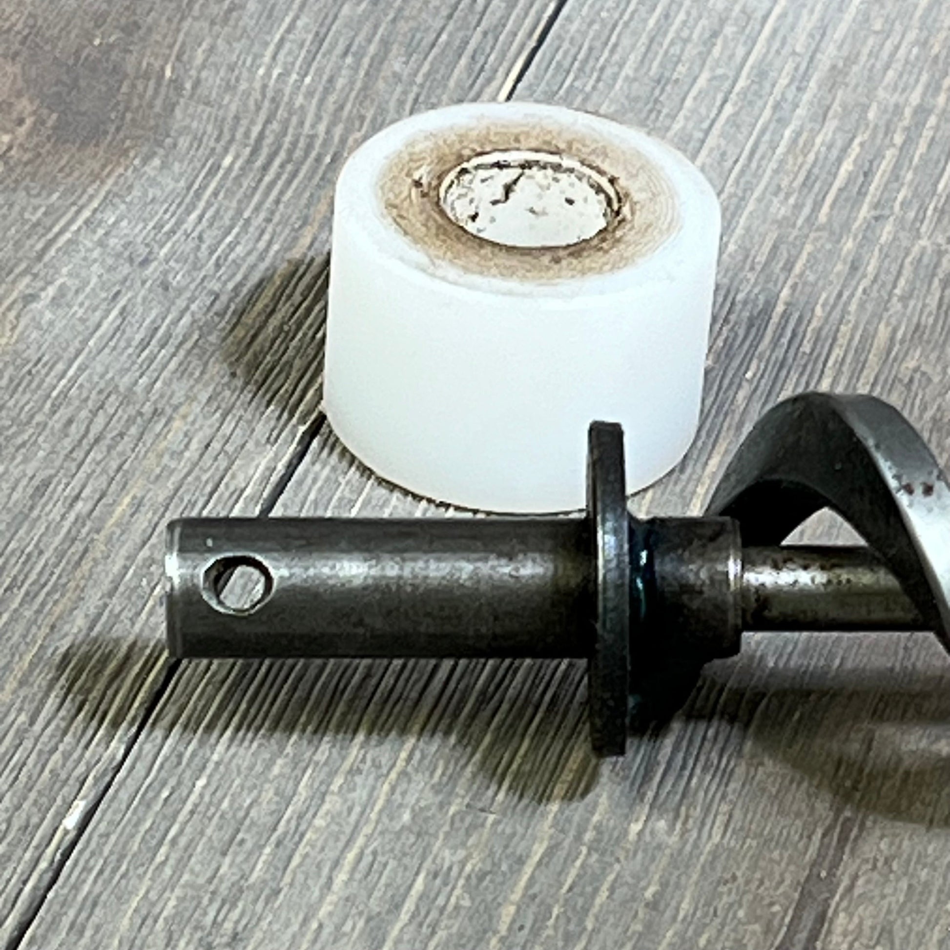 17-inch auger shaft and motor bushing kit for Traeger pellet grills, featuring durable metal construction on wooden surface.