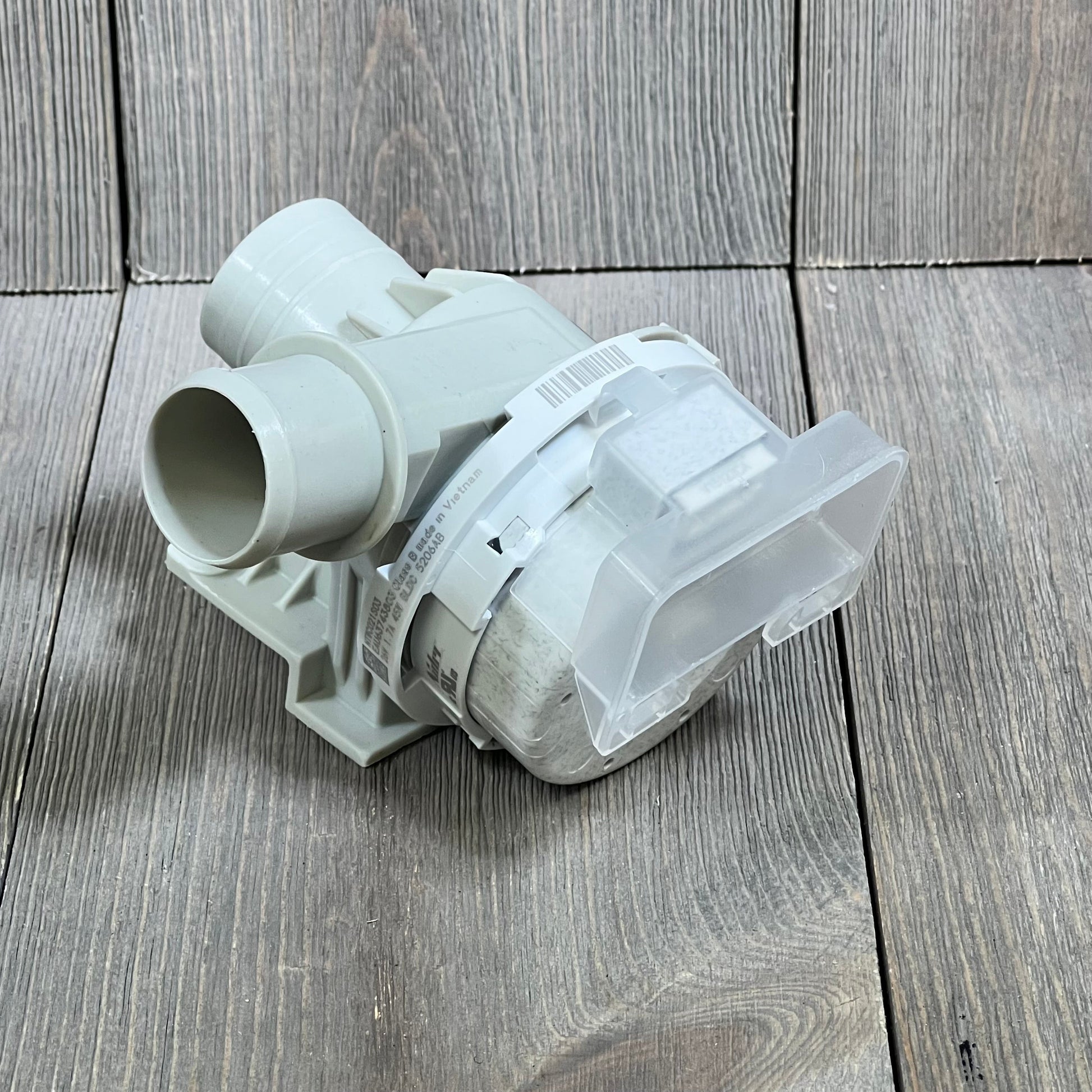 Upgraded LG washer drain pump assembly on wooden surface, compatible with models WT7800CV, WT7100CW, and more.