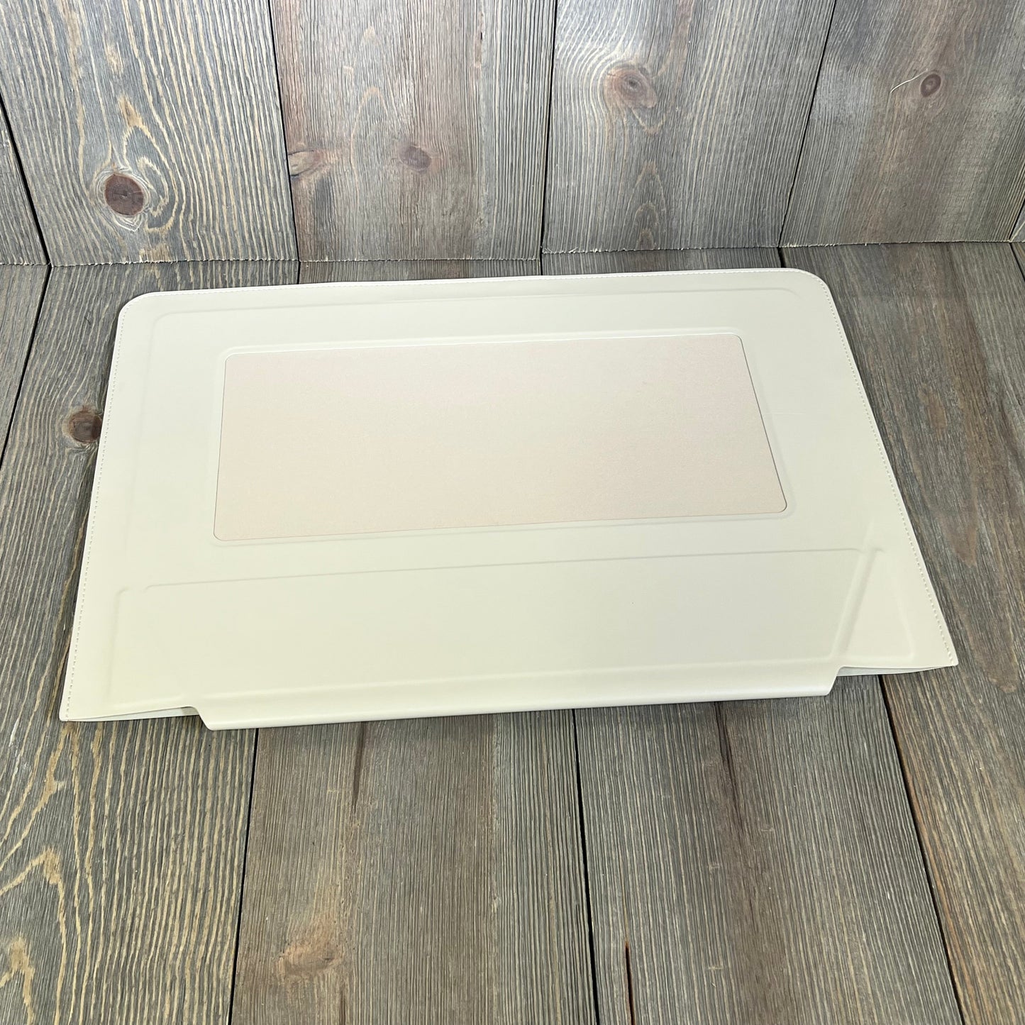 Ultra-slim MOFT Beach White laptop sleeve bag with expandable storage, designed for 15"-16" MacBook, on wooden background.
