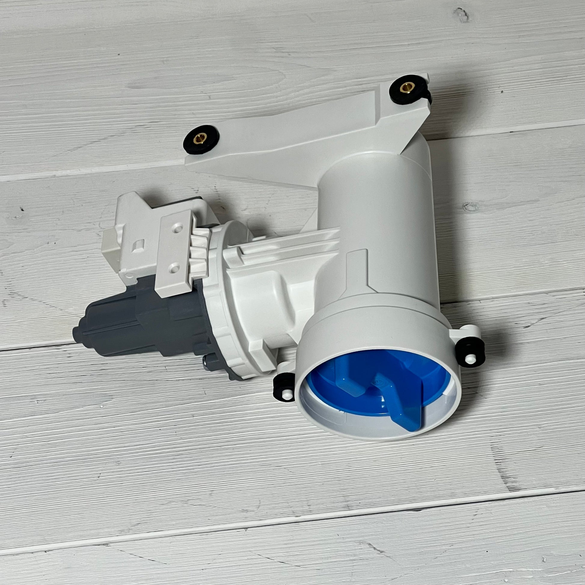 White washer drain pump with blue filter, compatible with G.E models GFW550SSN and GFW510SCN series, on wooden surface.