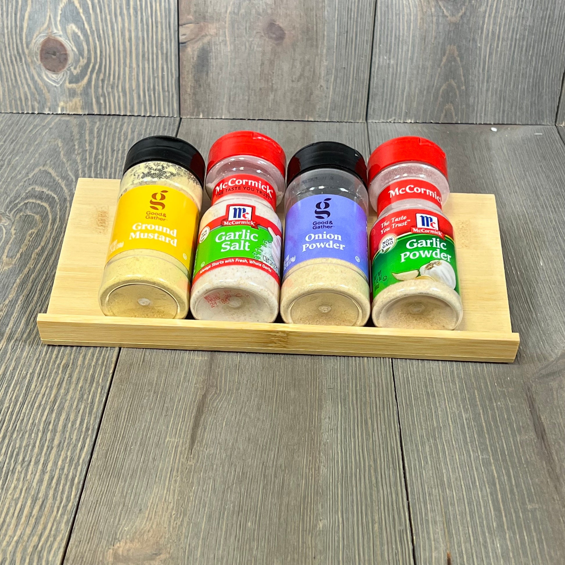 Bamboo spice rack with seasoning jars displayed, showcasing stackable and organized kitchen storage solution.