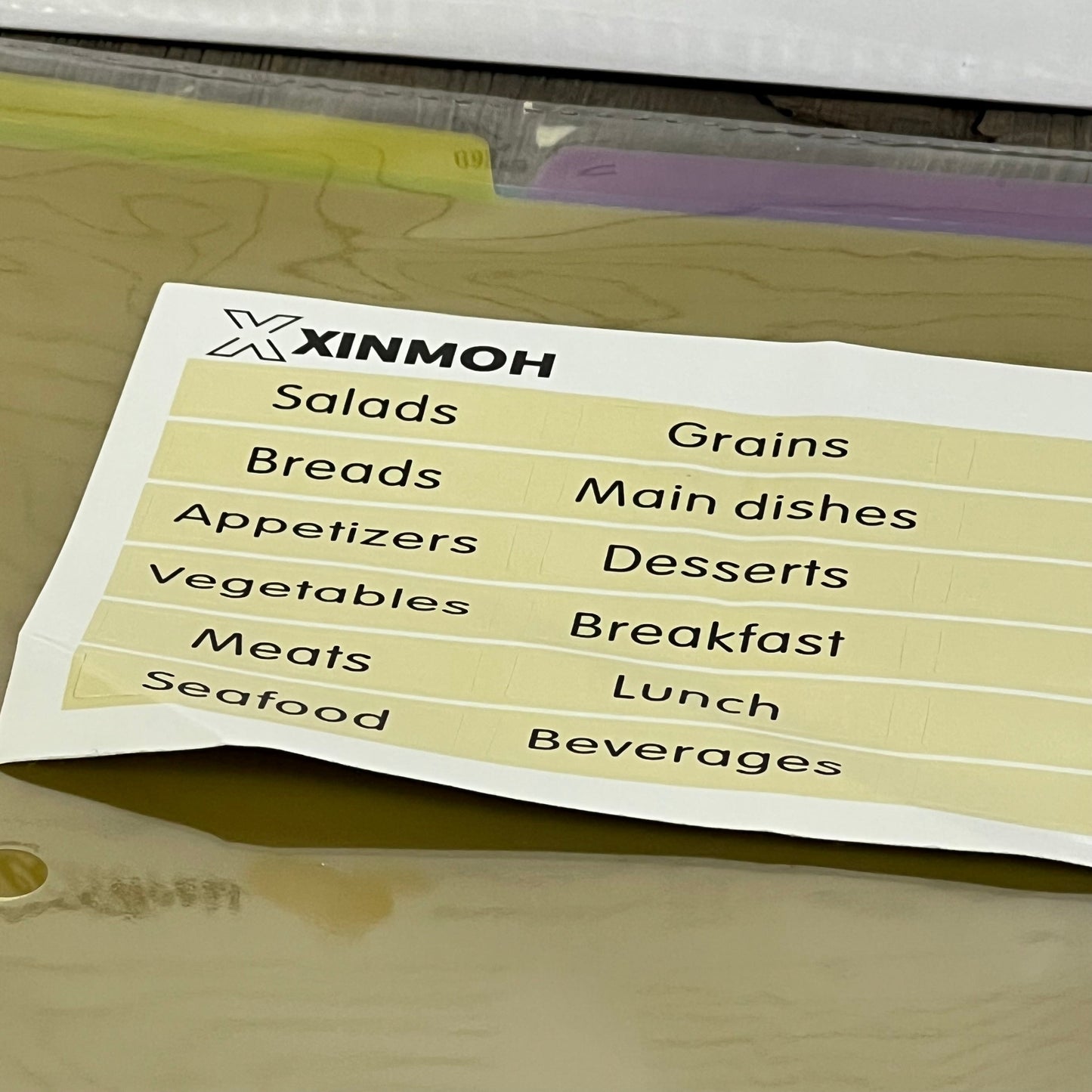 Recipe book with removable labels featuring categories like salads, grains, and desserts for easy organization.