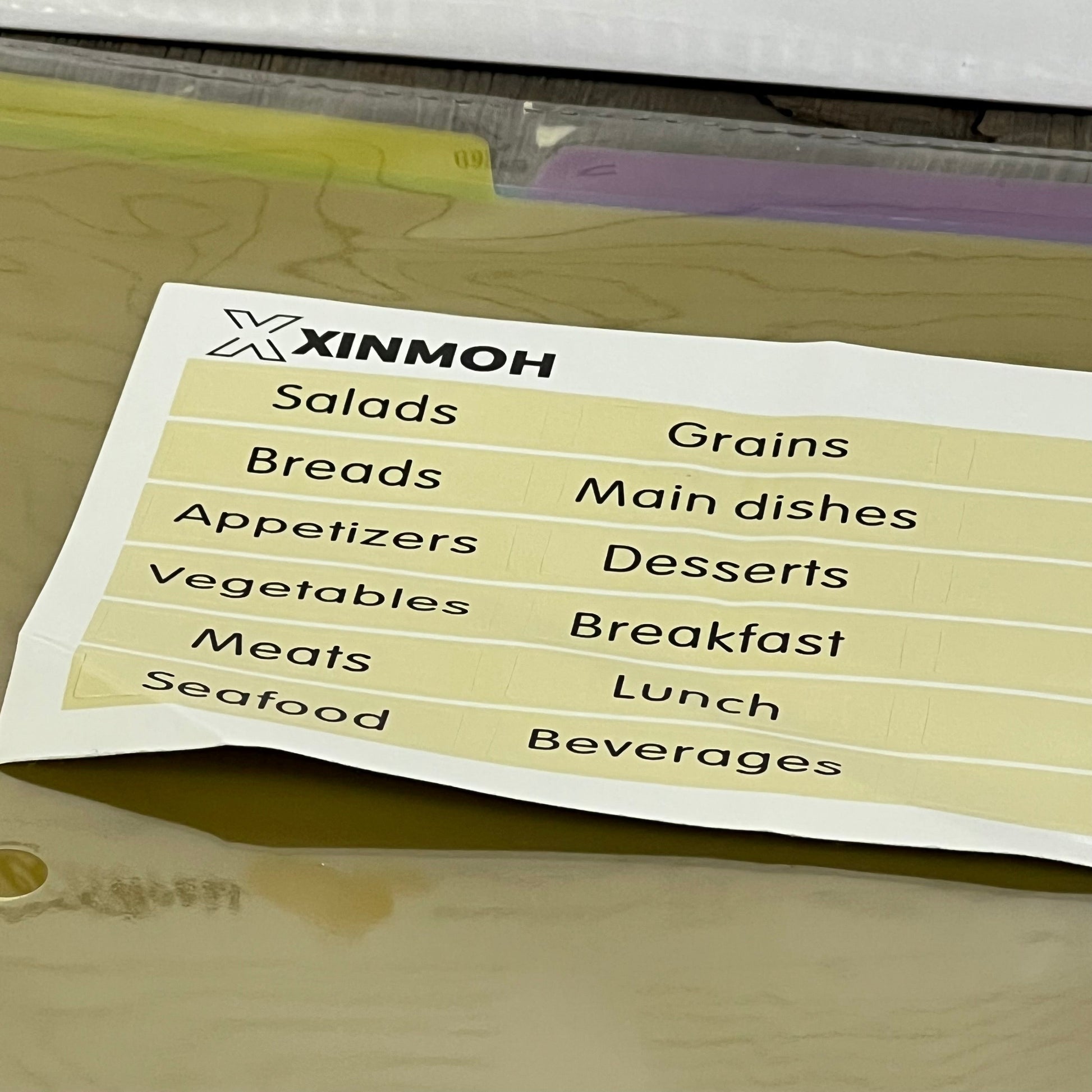 Recipe book with removable labels featuring categories like salads, grains, and desserts for easy organization.