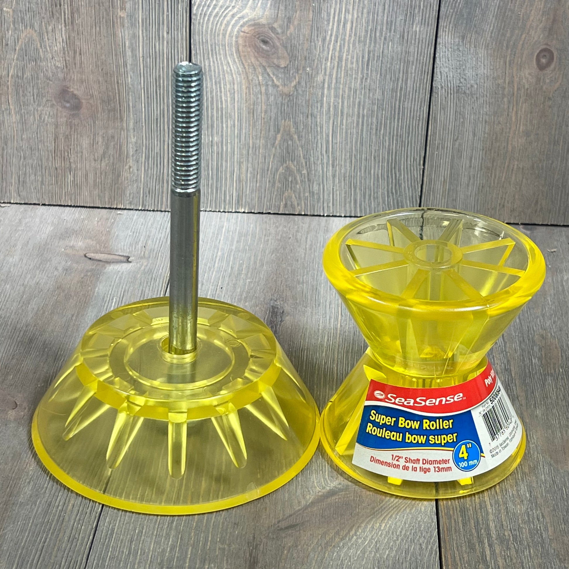 Yellow SeaSense Super Polymer Bow Roller, 4-inch, displayed with packaging on a wooden background. Ideal for marine use.