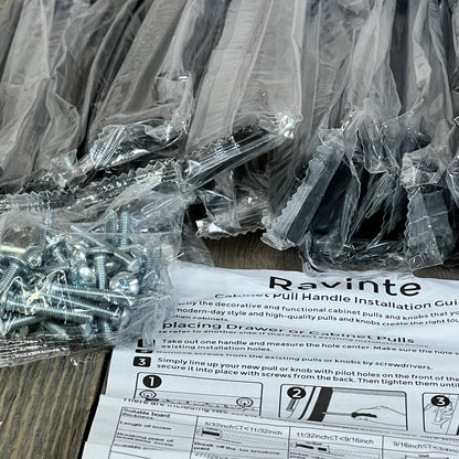 Matte black Ravinte drawer handles with screws and installation guide on a wooden surface.