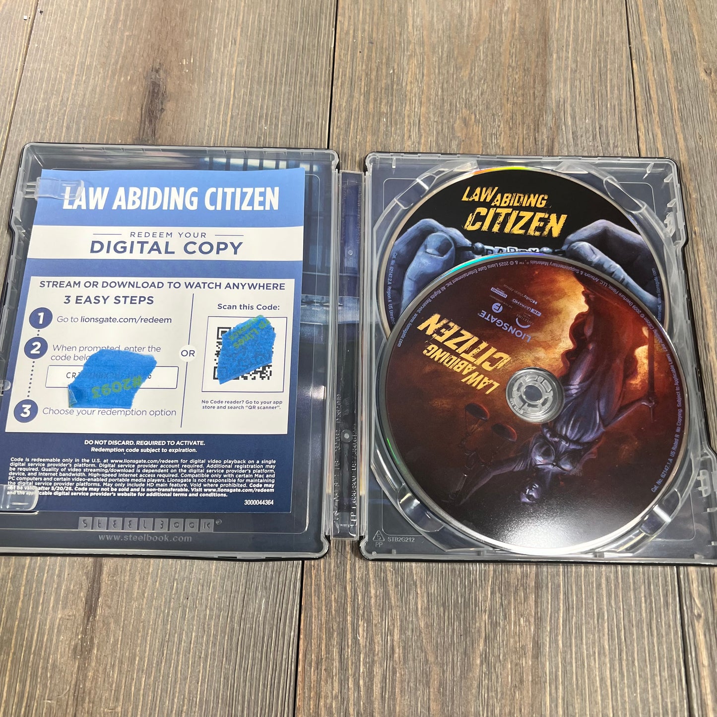 "Law Abiding Citizen" 4K UHD, Blu-ray, and digital copy in an open steelbook case on a wooden surface.