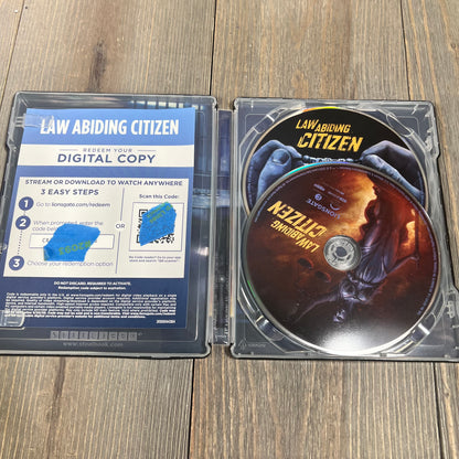 "Law Abiding Citizen" 4K UHD, Blu-ray, and digital copy in an open steelbook case on a wooden surface.