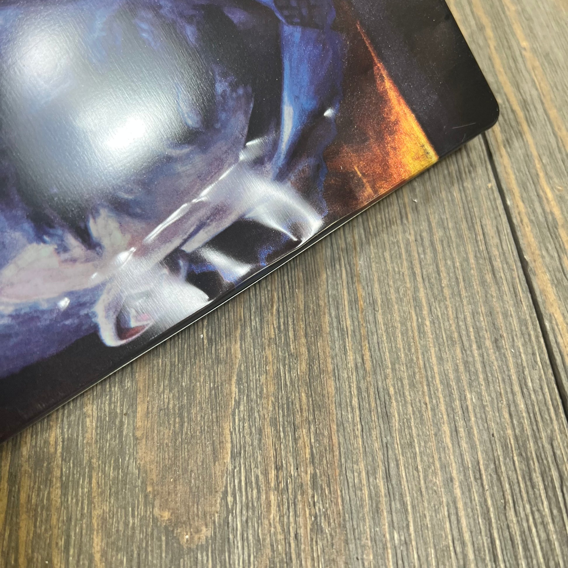 Alt text: Close-up of a dented corner on a steelbook case for "Law Abiding Citizen" on a wooden surface.