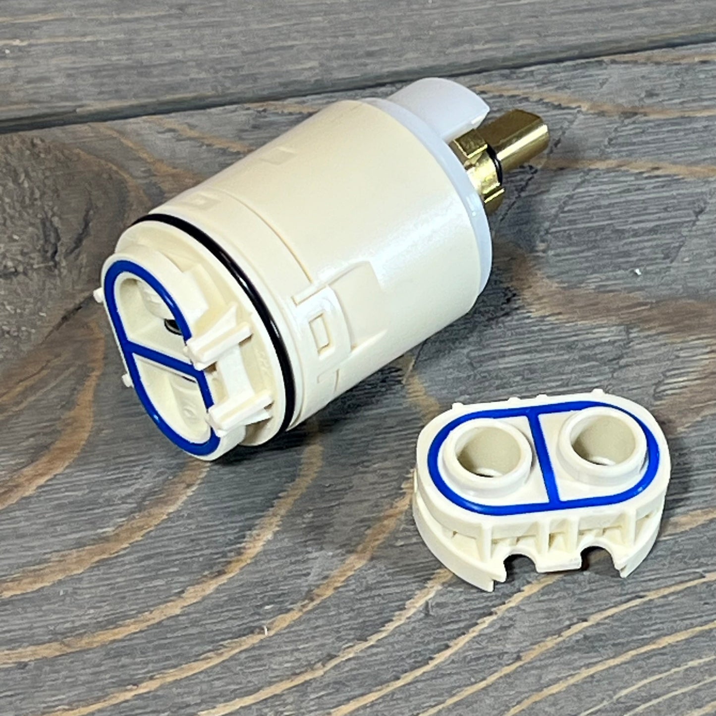 FlowRite RP70538/73625 cartridge and valve assembly on wooden surface.