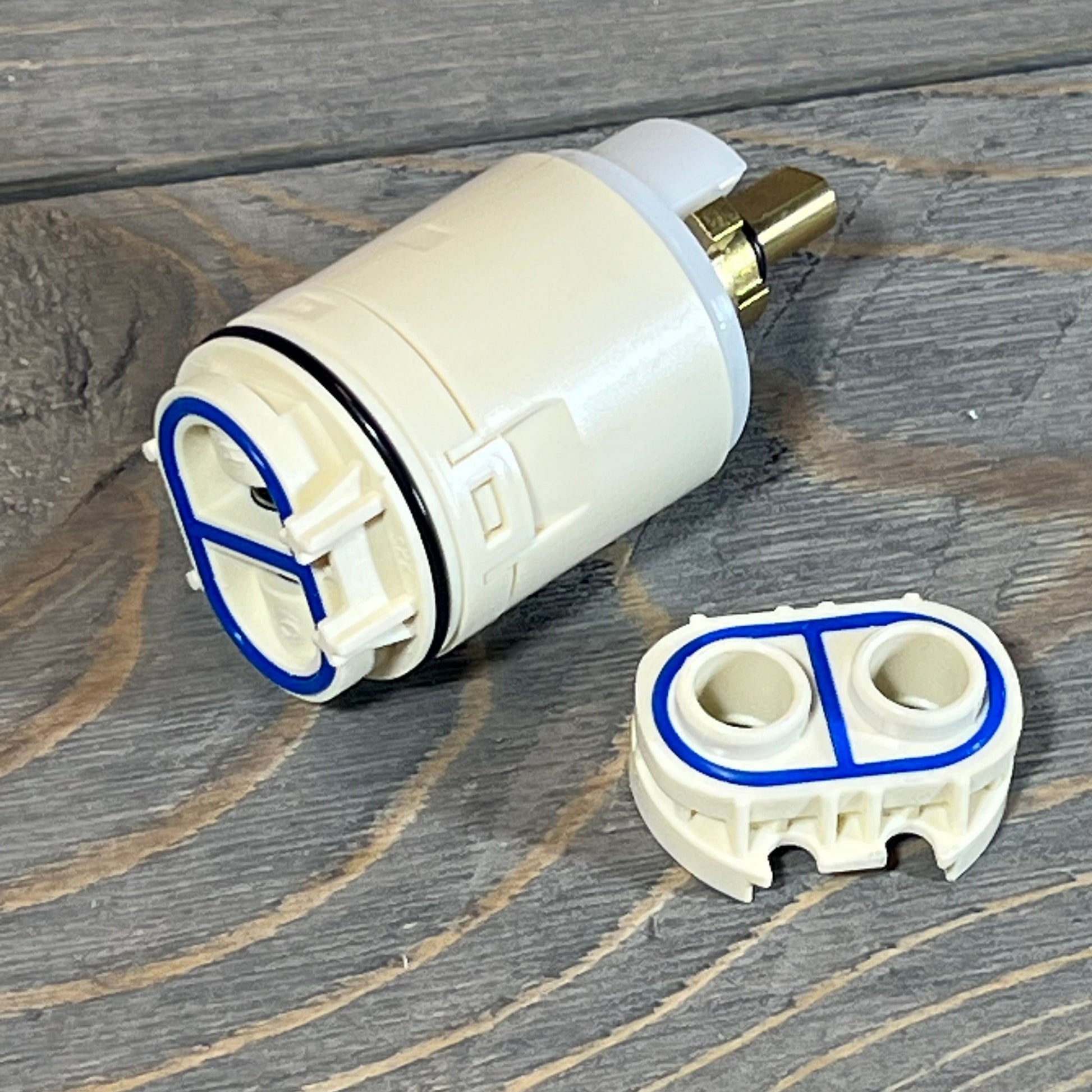 FlowRite RP70538/73625 cartridge and valve assembly on wooden surface.