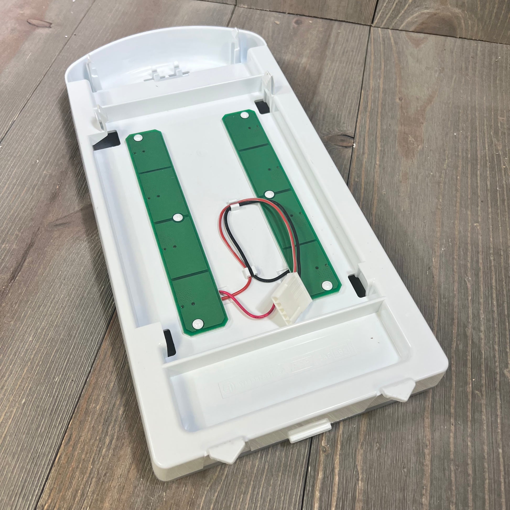 Alt text: LED light module assembly replacement for refrigerator, compatible with Whirlpool, Maytag, Amana, on wooden floor.