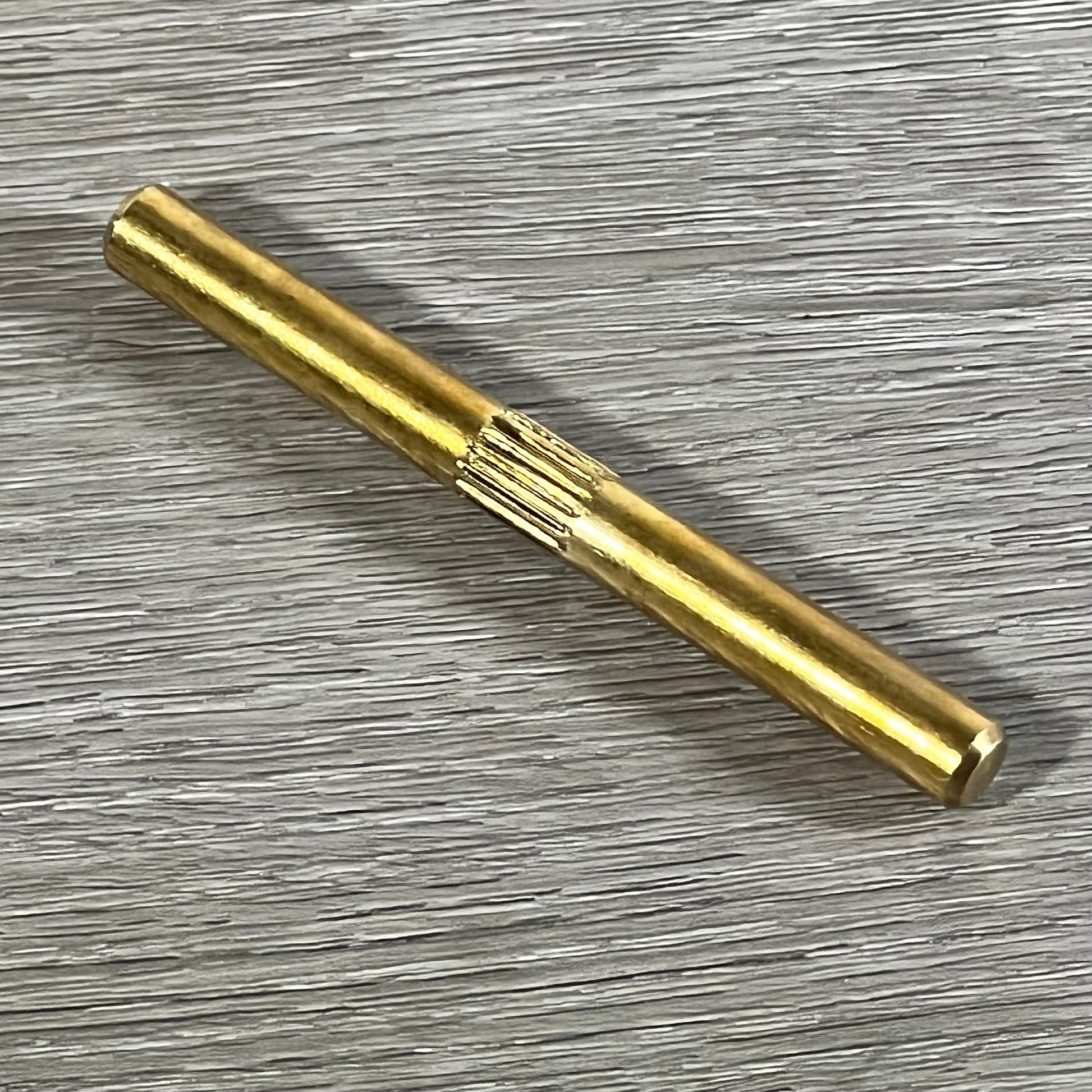 Golden brass component for LX65/88 acetylene regulator with precision design on a textured surface.