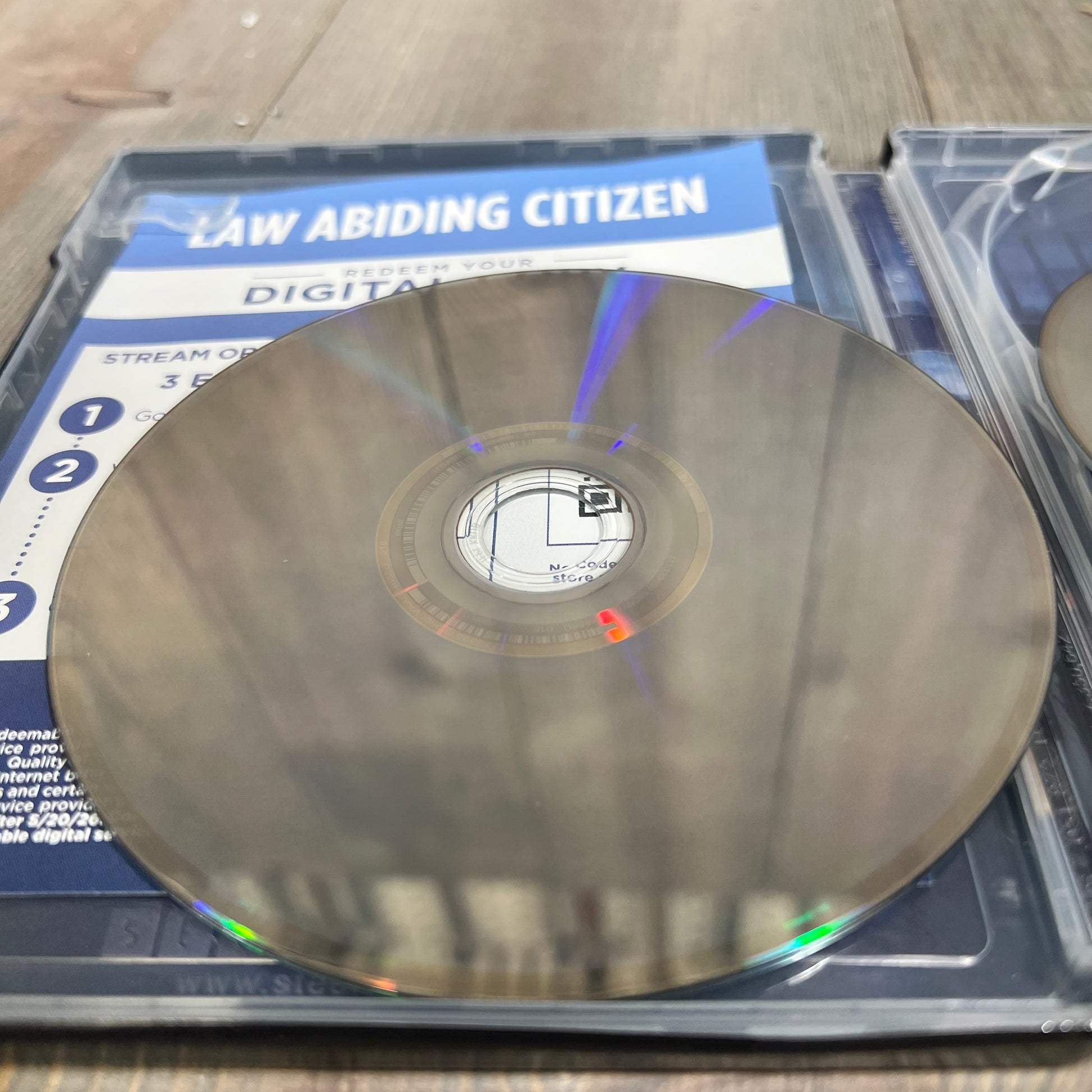 Alt text: "Law Abiding Citizen 4K UHD disc with digital code card inside a steelbook case."