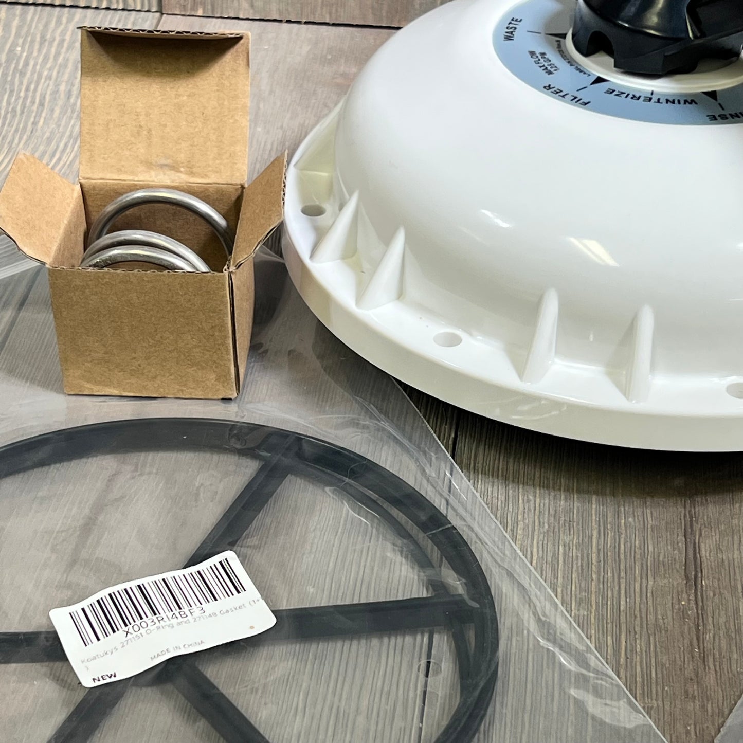 Alt text: Deecaray valve top assembly with diverter seal, compression spring, and gasket for 2-inch HiFlow valves on a wooden