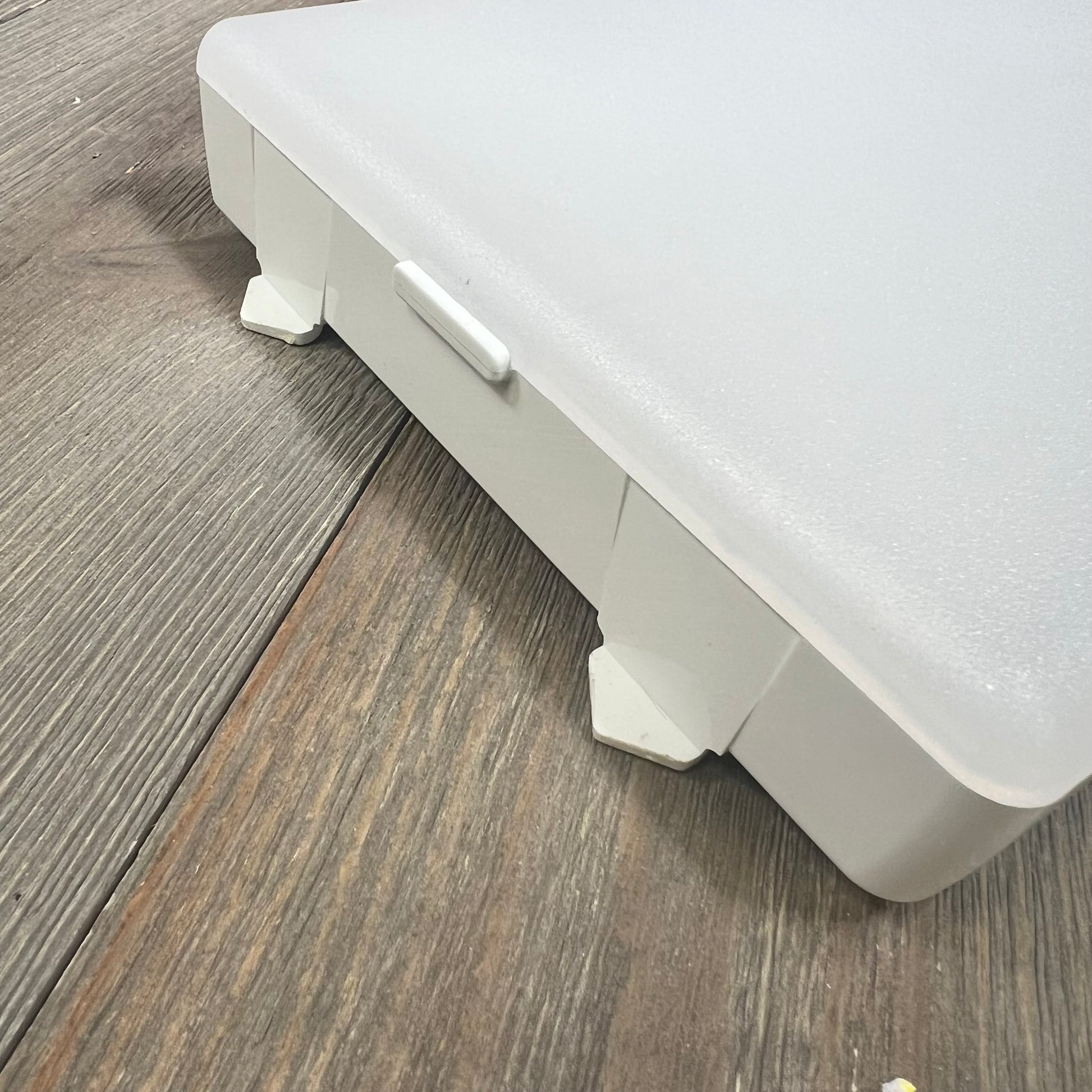 Refrigerator LED light module assembly on wooden surface.