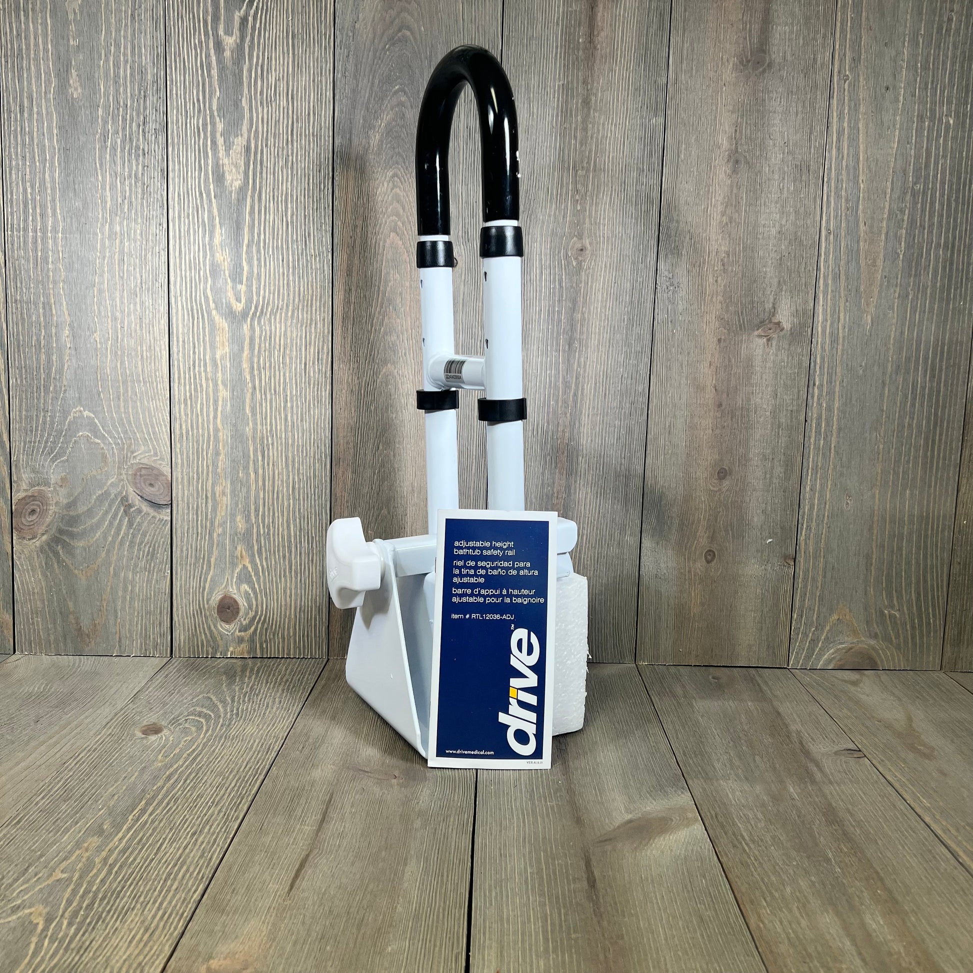 Adjustable white bathtub grab bar by Drive Medical, featuring a sturdy safety rail for enhanced bathroom stability.