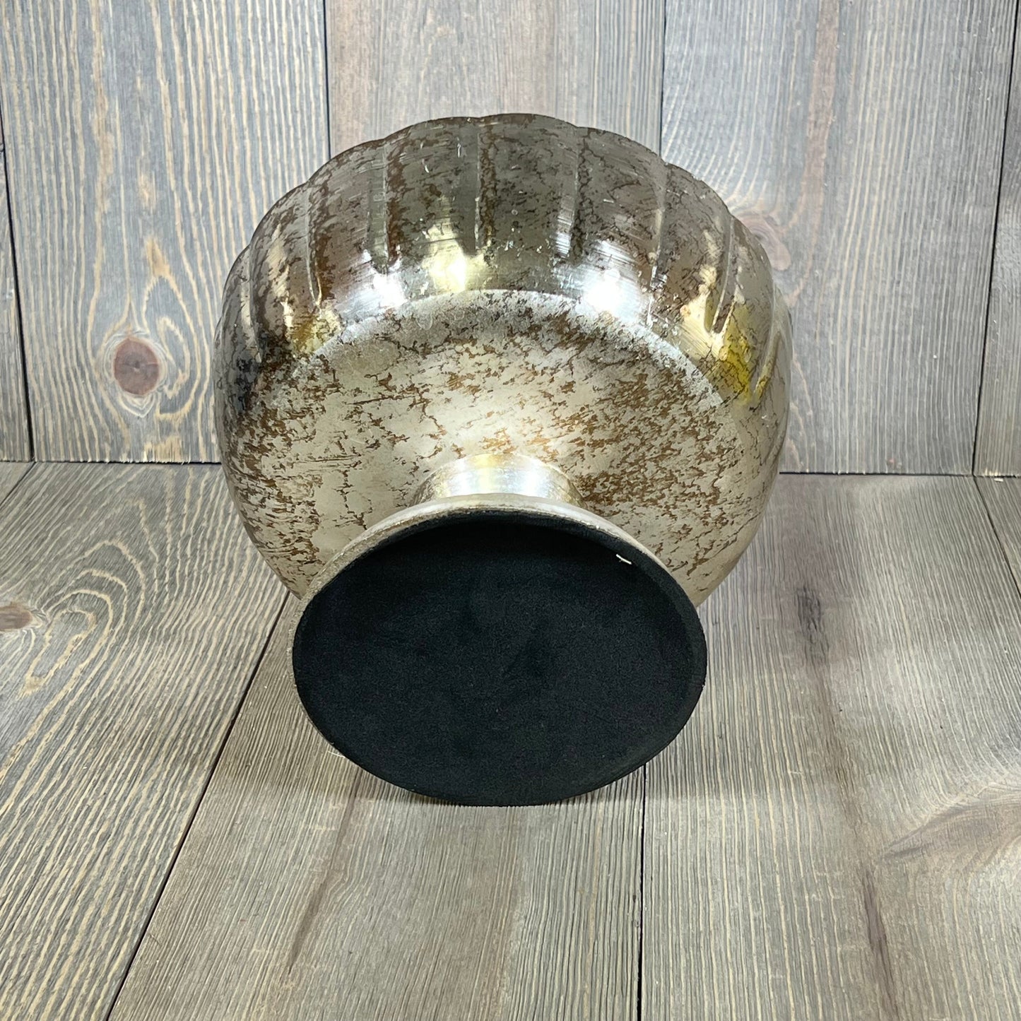 Distressed champagne metal compote bowl with vintage finish on wooden surface, ideal for elegant events.