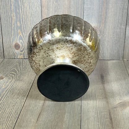 Distressed champagne metal compote bowl with vintage finish on wooden surface, ideal for elegant events.