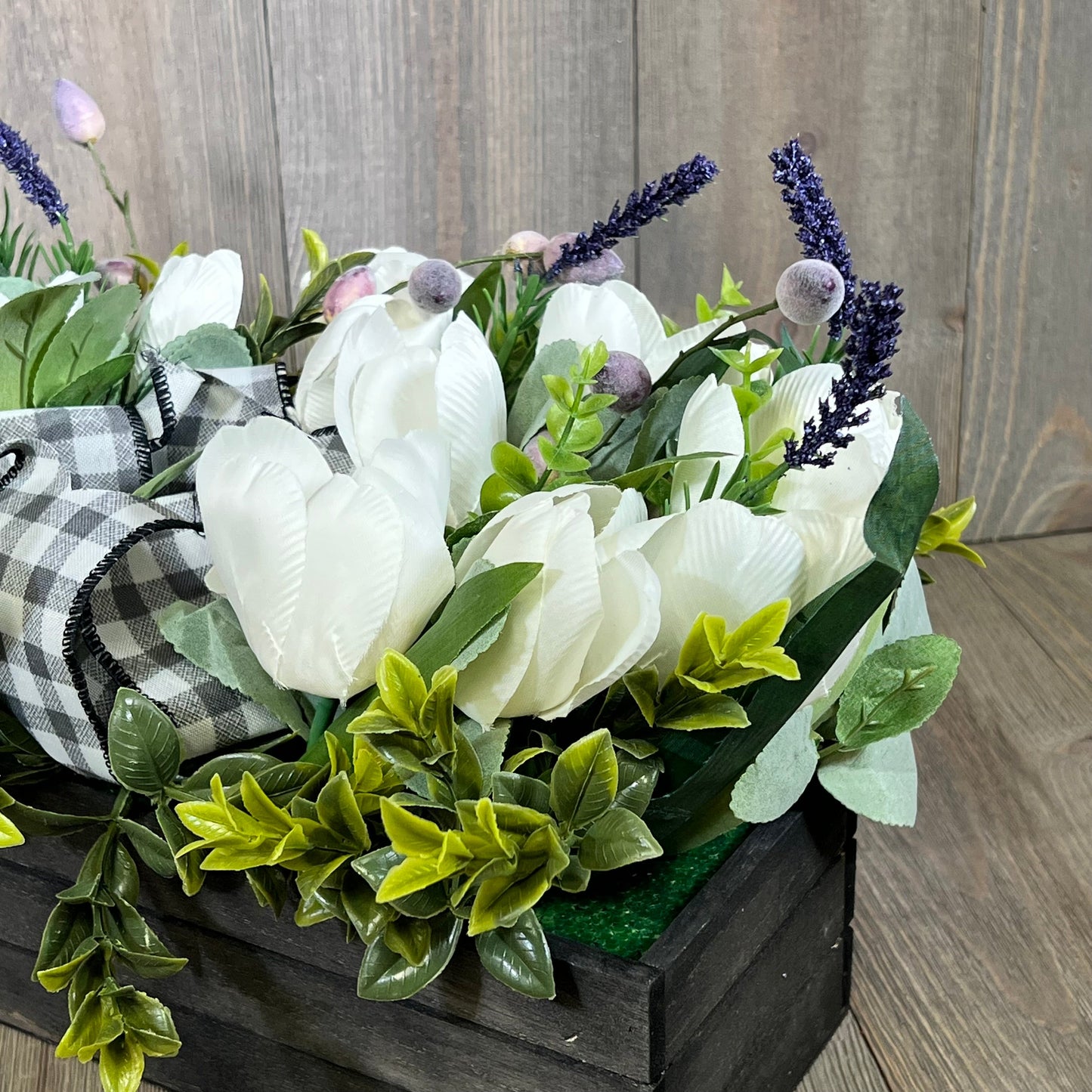 Artificial white tulips and lavender in a wood box with greenery, perfect for spring and Easter table decoration.