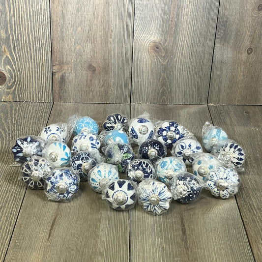 Assorted vintage blue ceramic knobs for cupboards, featuring colorful designs, perfect for kitchen furniture and wardrobes.