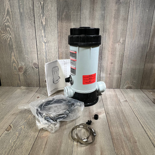 Automatic chlorinator feeder with accessories on wooden background, ideal for pool and garden maintenance.