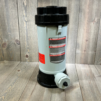 Automatic chlorinator feeder with black lid and safety labels for swimming pools and ponds.