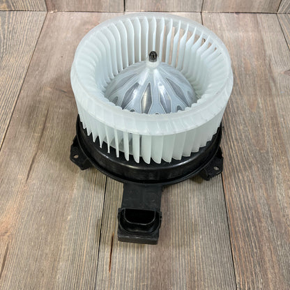 AC blower motor with fan assembly for Honda Accord 2013-2017, shown on a wooden surface. Ideal for HVAC replacement.