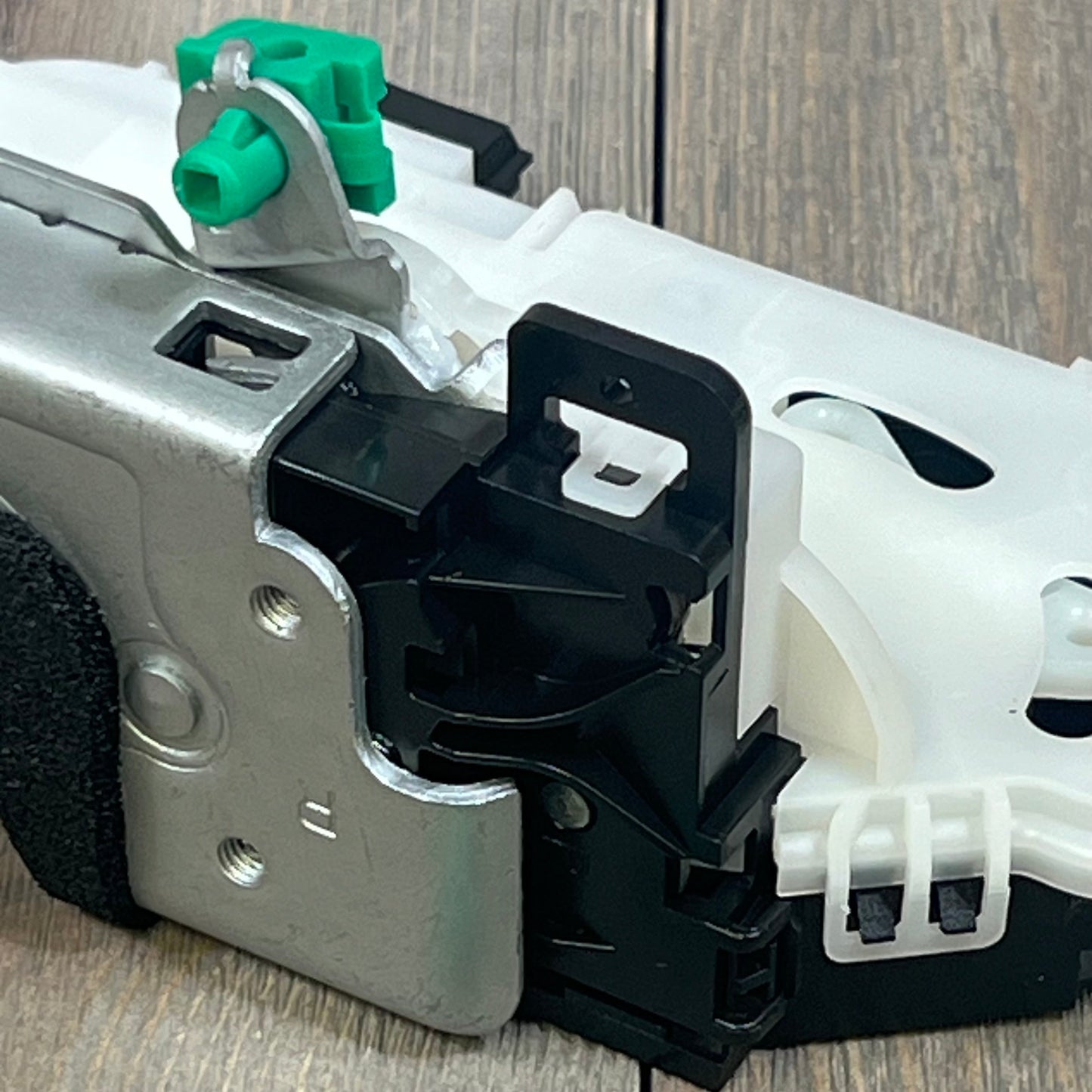 Close-up of ApplianPar rear passenger side door lock actuator latch with metal and plastic components for Ford and Lincoln.