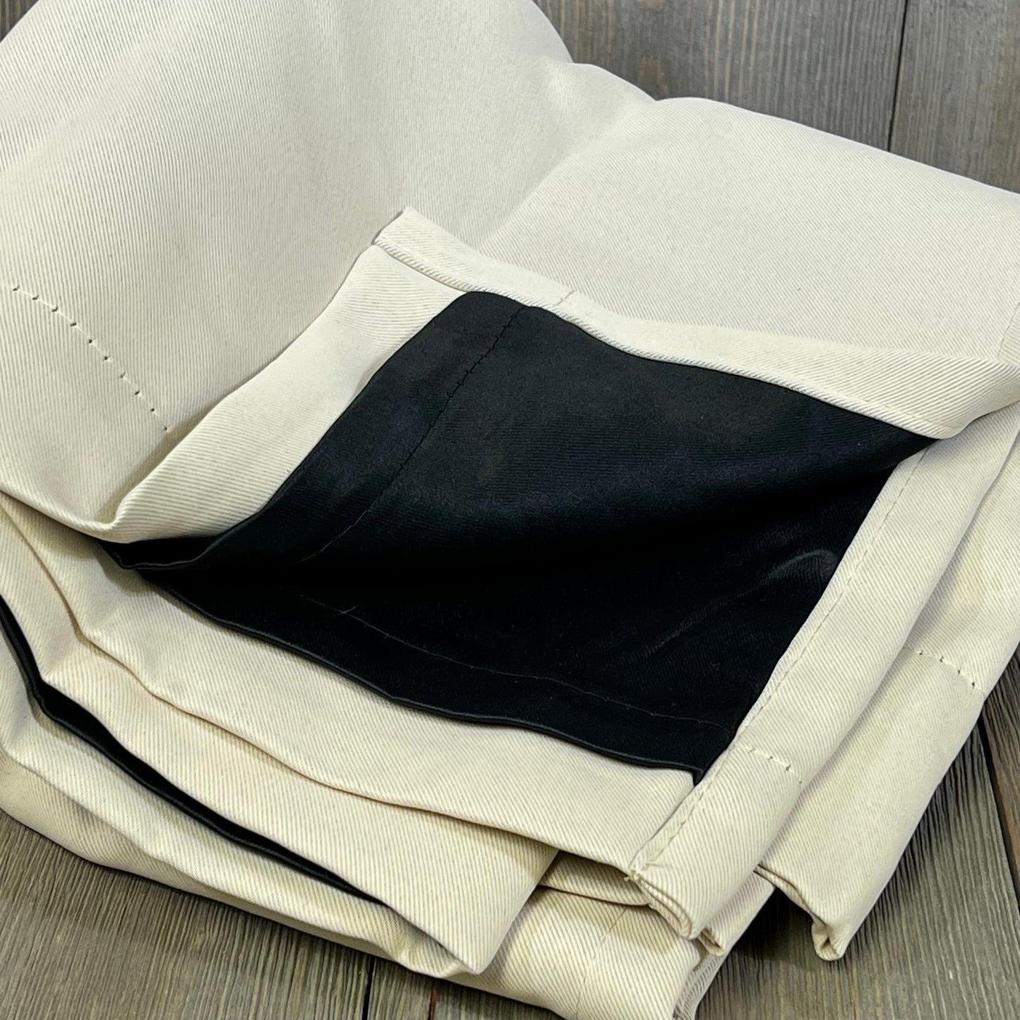 Champagne blackout curtains with black liner, folded to show thermal insulation and soundproof features.