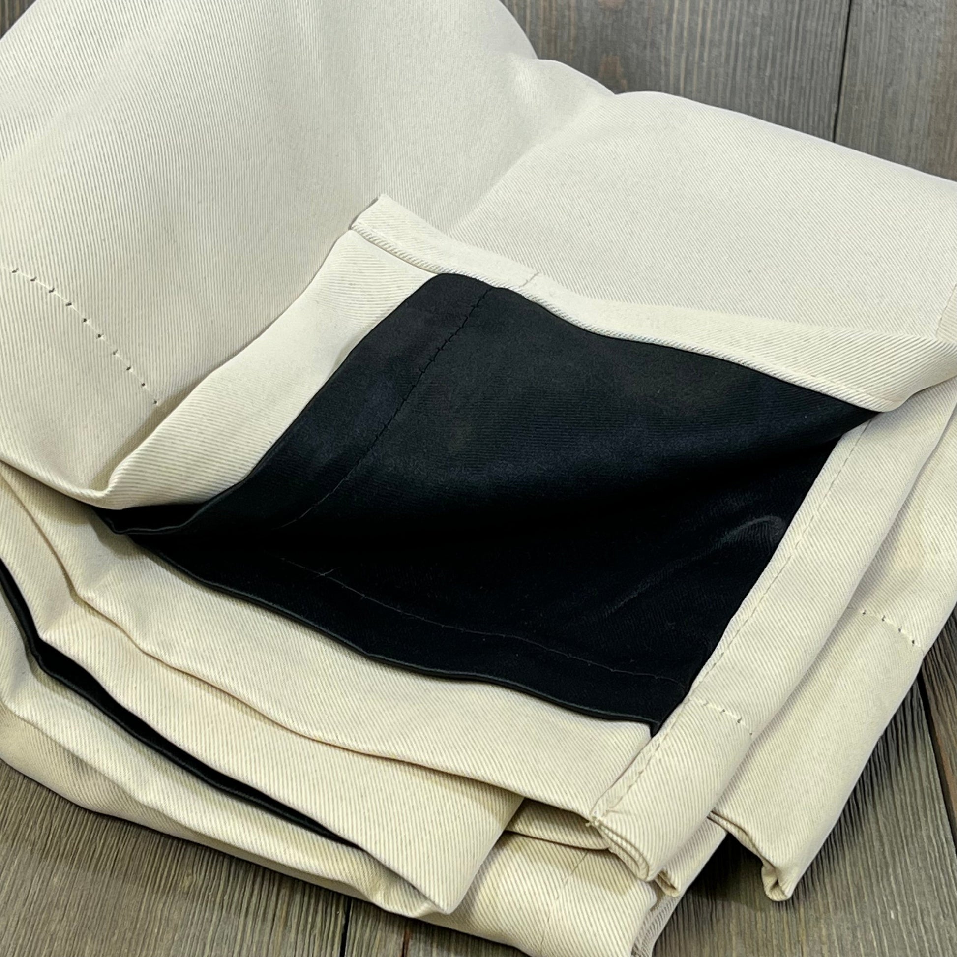 Champagne blackout curtains with black liner, folded to show thermal insulation and soundproof features.