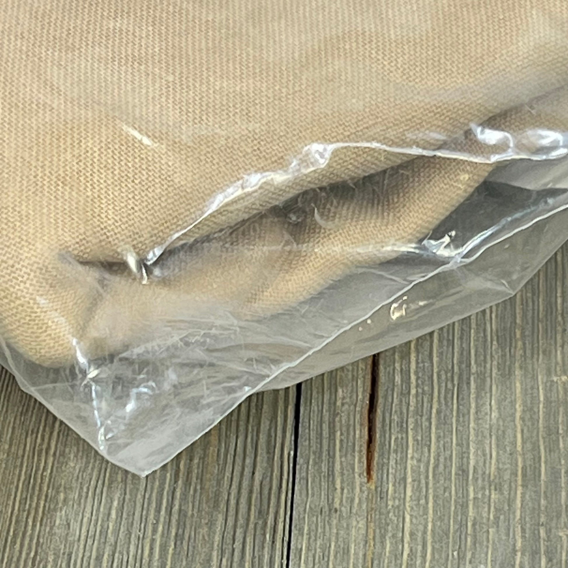 Linen blend burlap curtain in protective packaging, showcasing texture and thickness, ideal for living room privacy.