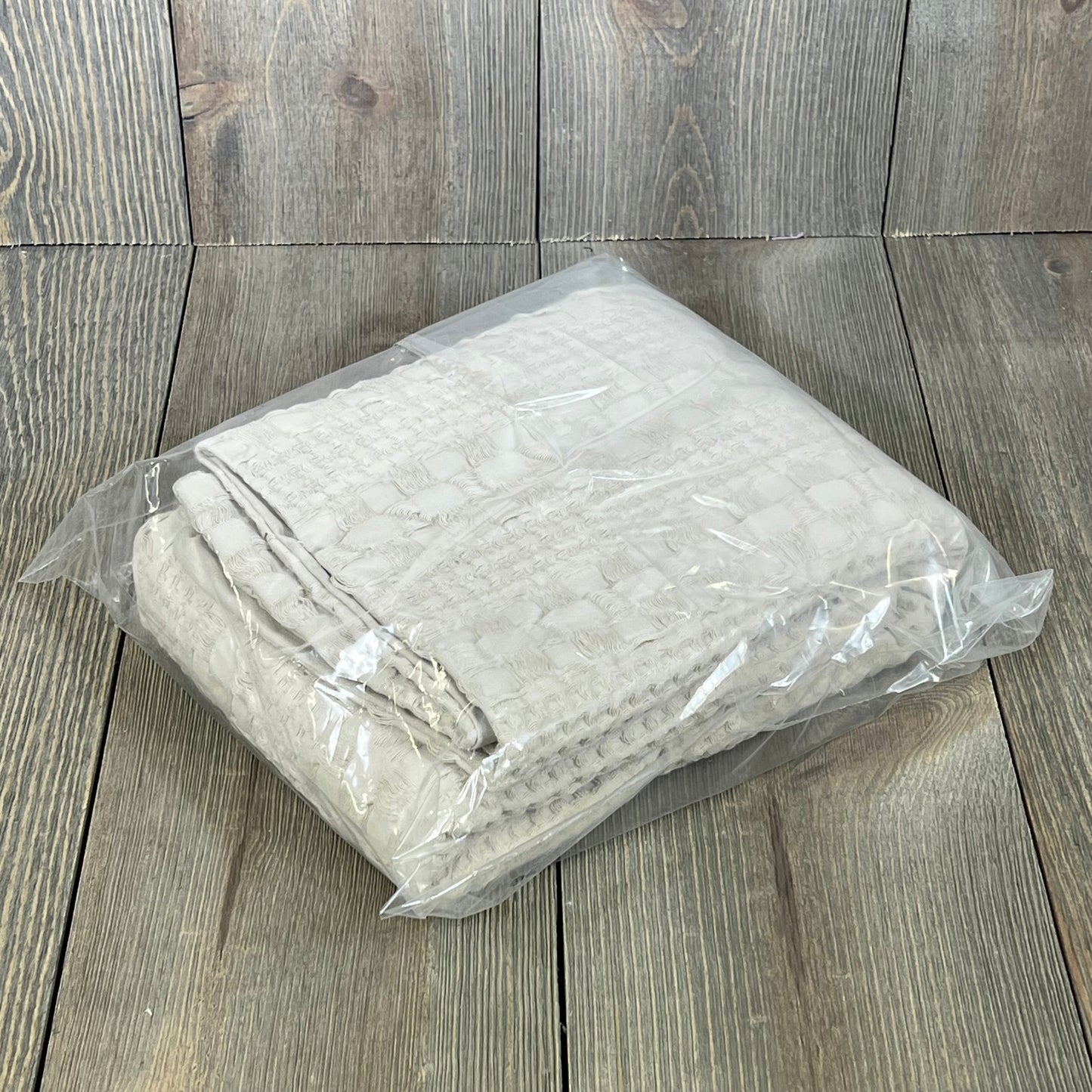 Waffle weave Euro sham covers in oatmeal color, packaged neatly, enhance your bedroom's luxury decor.