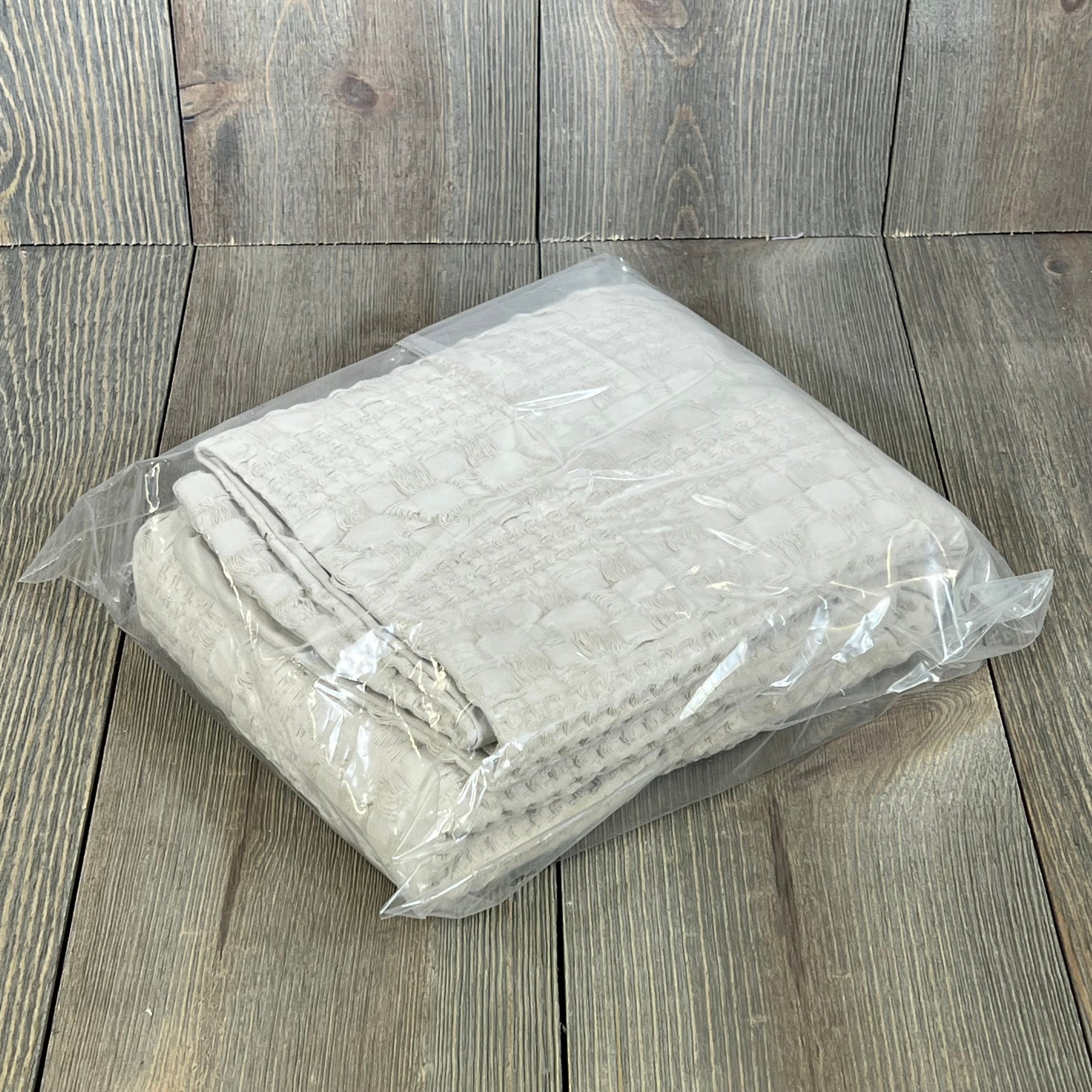 Waffle weave Euro sham covers in oatmeal color, packaged neatly, enhance your bedroom's luxury decor.
