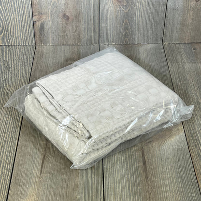 Waffle weave Euro sham covers in oatmeal color, packaged neatly, enhance your bedroom's luxury decor.