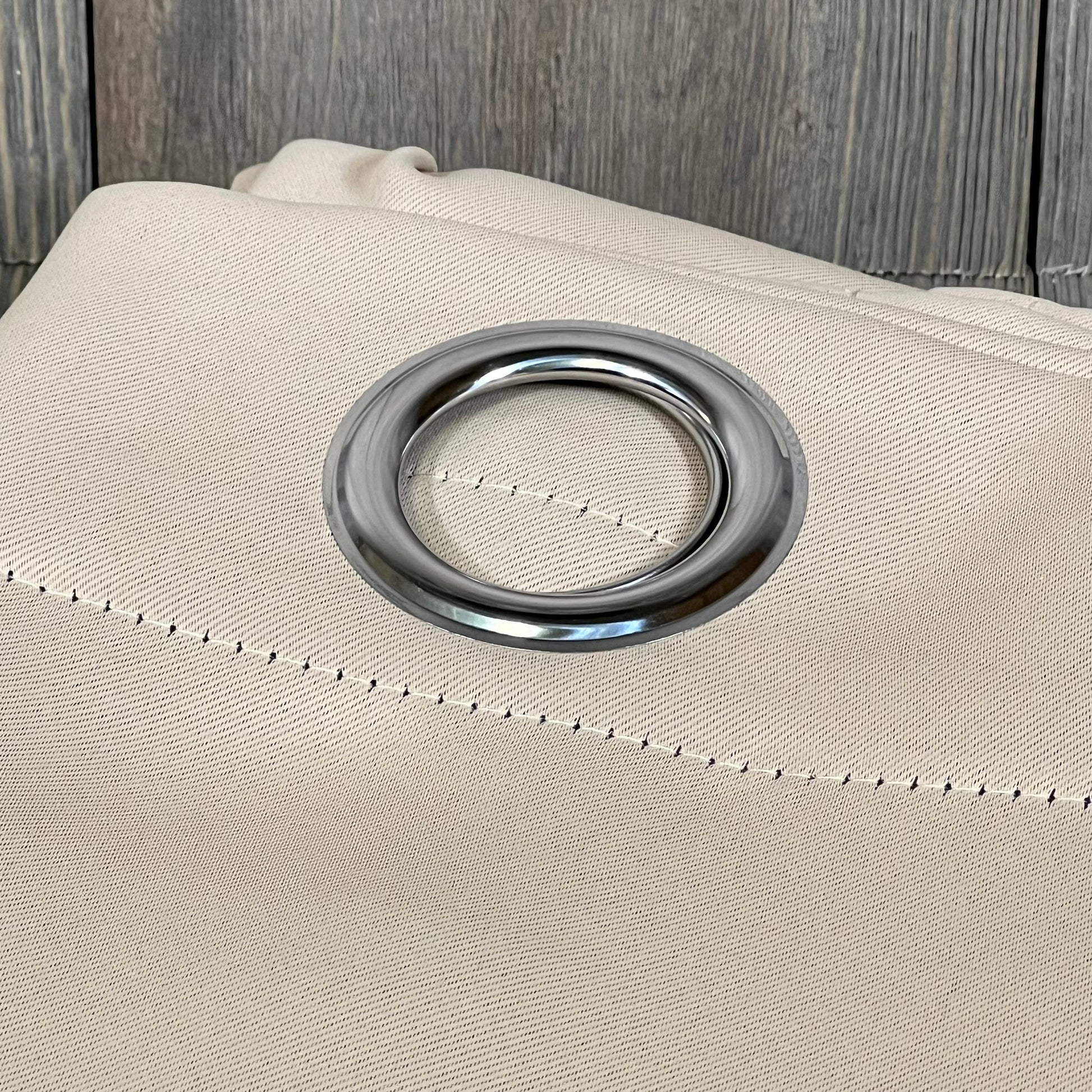 Beige ChrisDowa blackout curtain with silver grommet, showcasing thick fabric for bedroom light blocking.