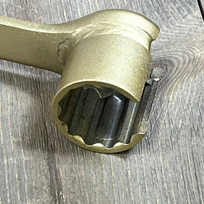Gold-toned ANTUKO IPR Valve Injector Pressure Regulator Removal Tool with detailed gear design on wooden surface.