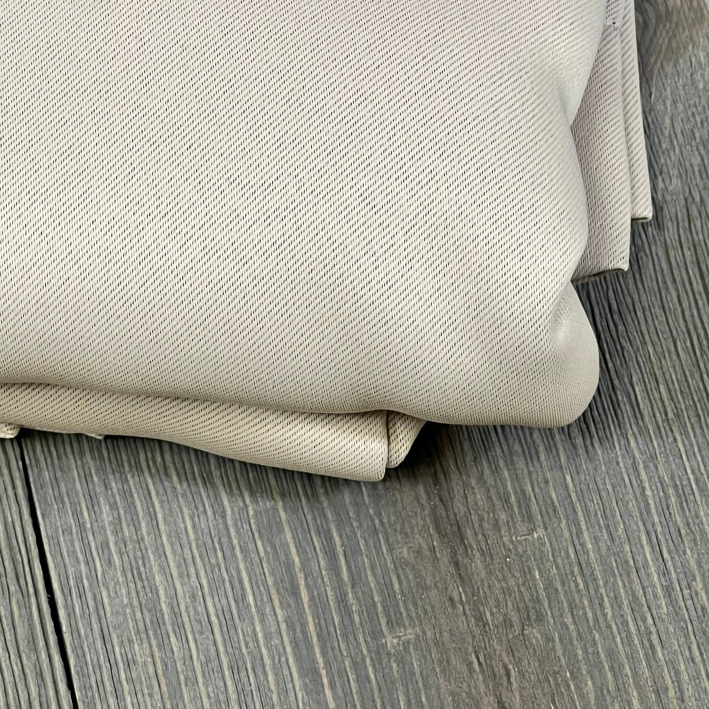 Beige ChrisDowa blackout curtains folded, highlighting thick, thermal-insulated fabric texture for bedroom windows.